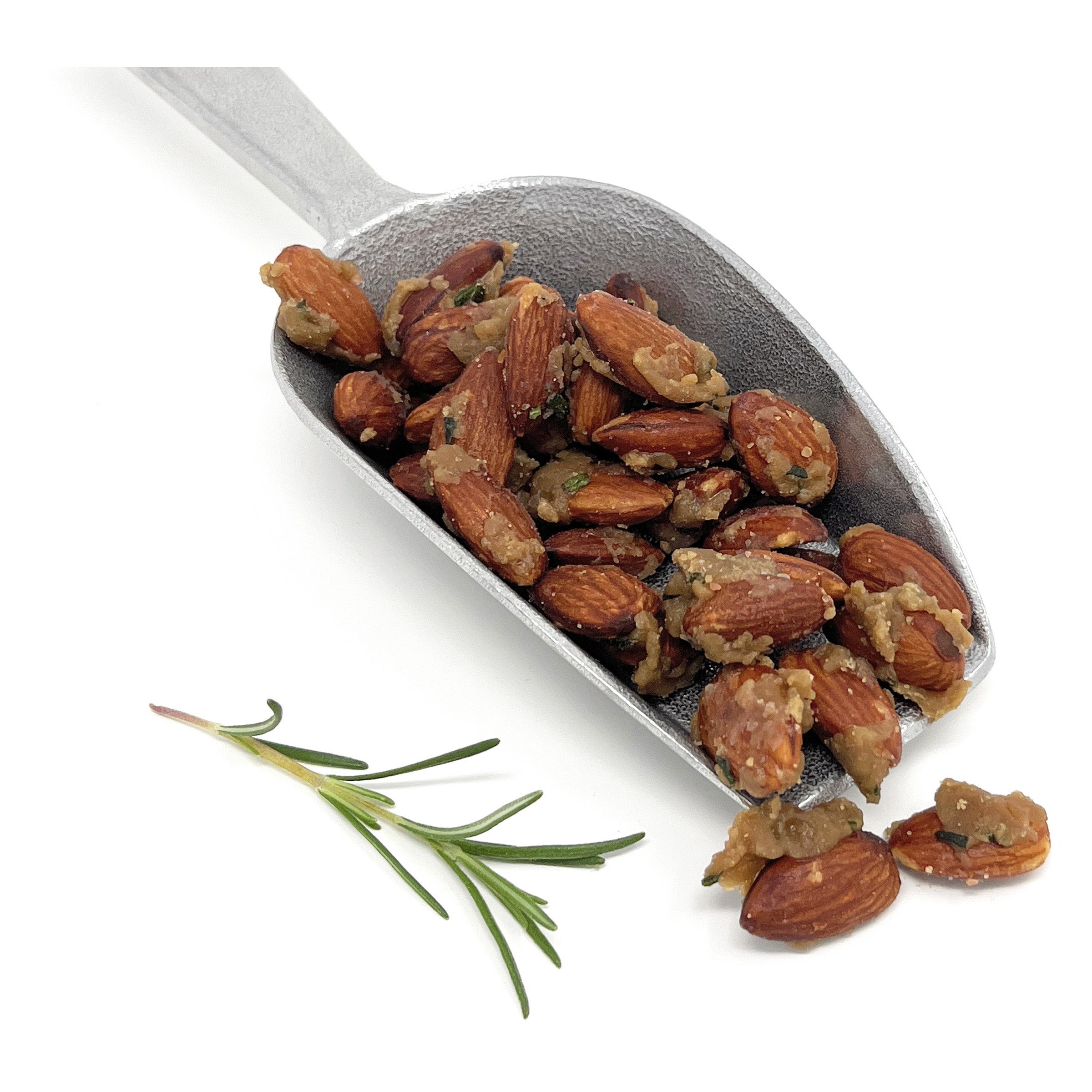 Metal scoop filled with roasted almonds on a white background